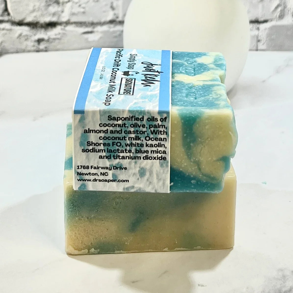 Bar of Pacific Drift soap with ingredient label on a white background