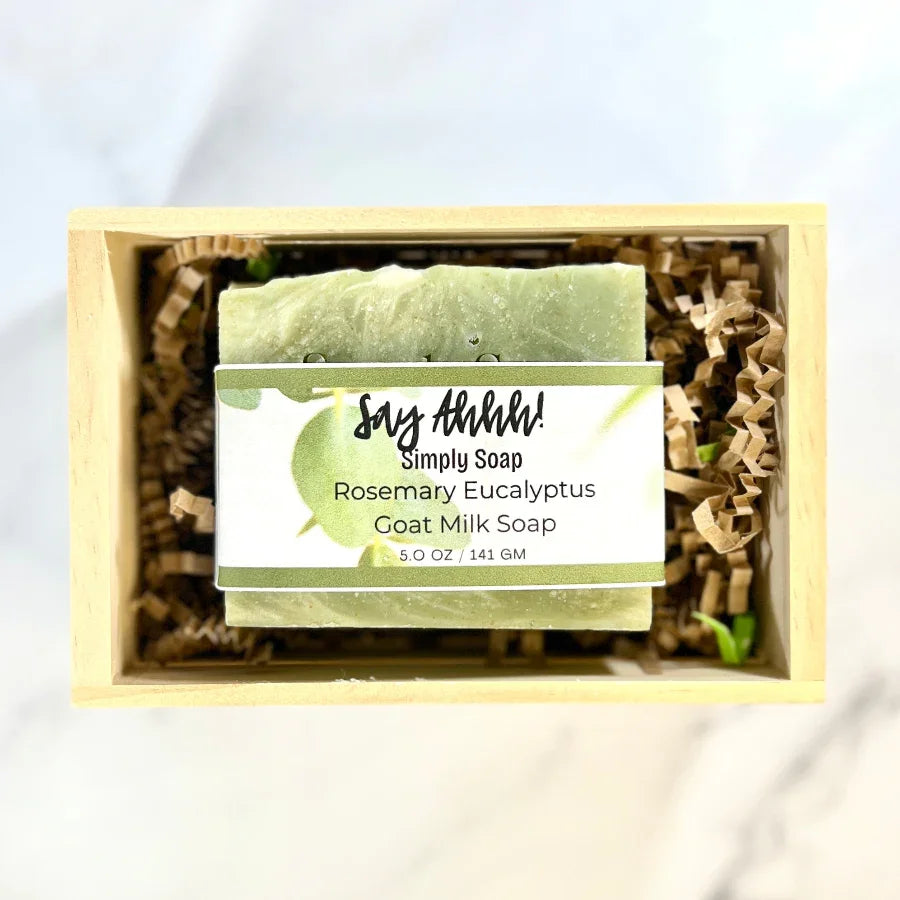 Rosemary Eucalyptus Goat milk soap bar in a wooden box with a label on a white background