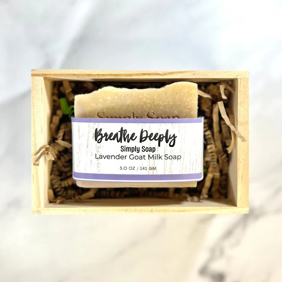 Bar of soap with a label in a wooden box on a light background