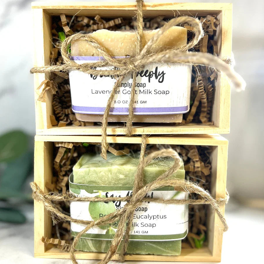 Two bars of soap in a wooden box with twine, one lavender and one eucalyptus scented.