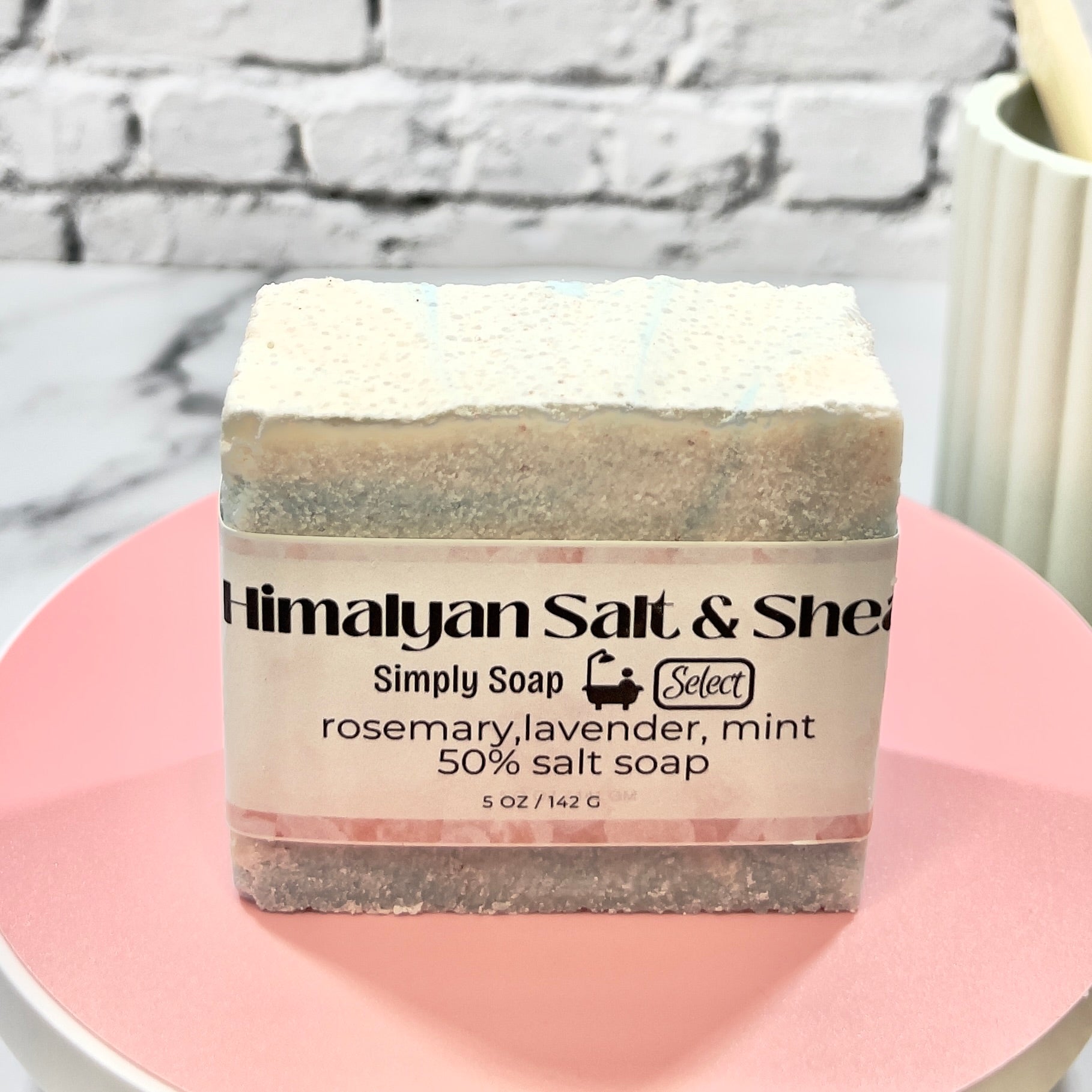 Bar of Himalayan Salt & Shea soap on a pink plate with a marble background