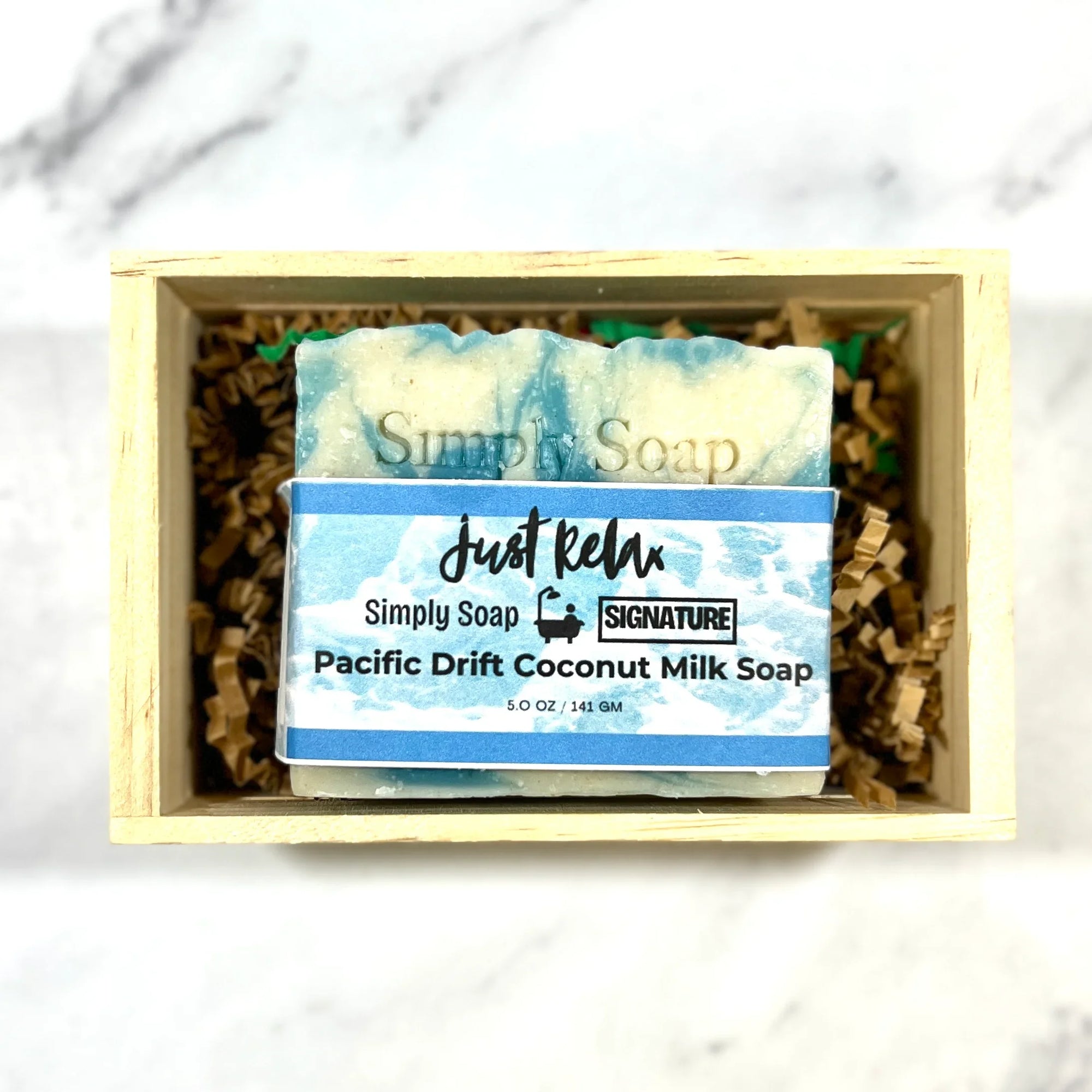 Pacific Drfit Coconut milk soap bar in a wooden box with a marble background