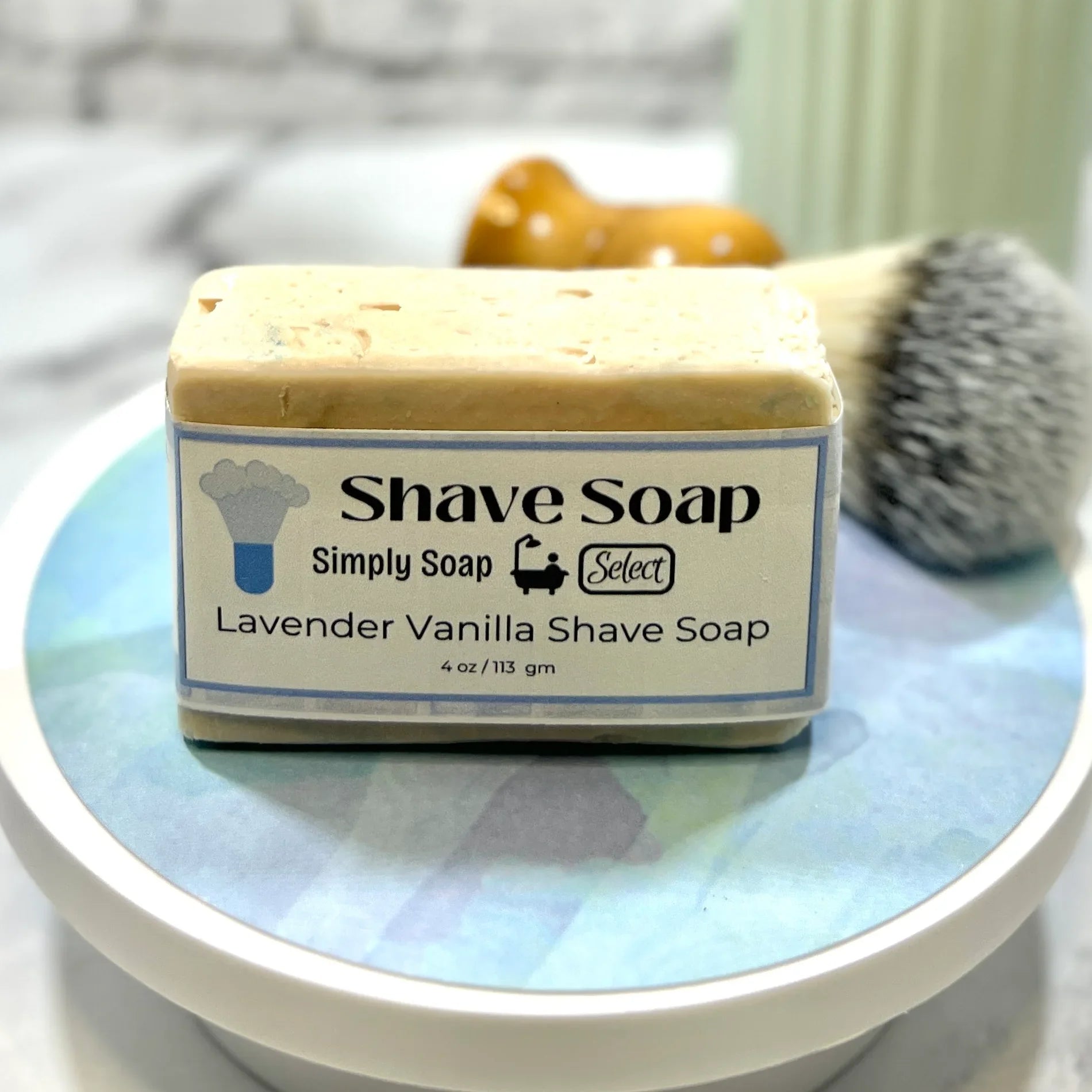 Bar of shave soap with a label on a marble surface