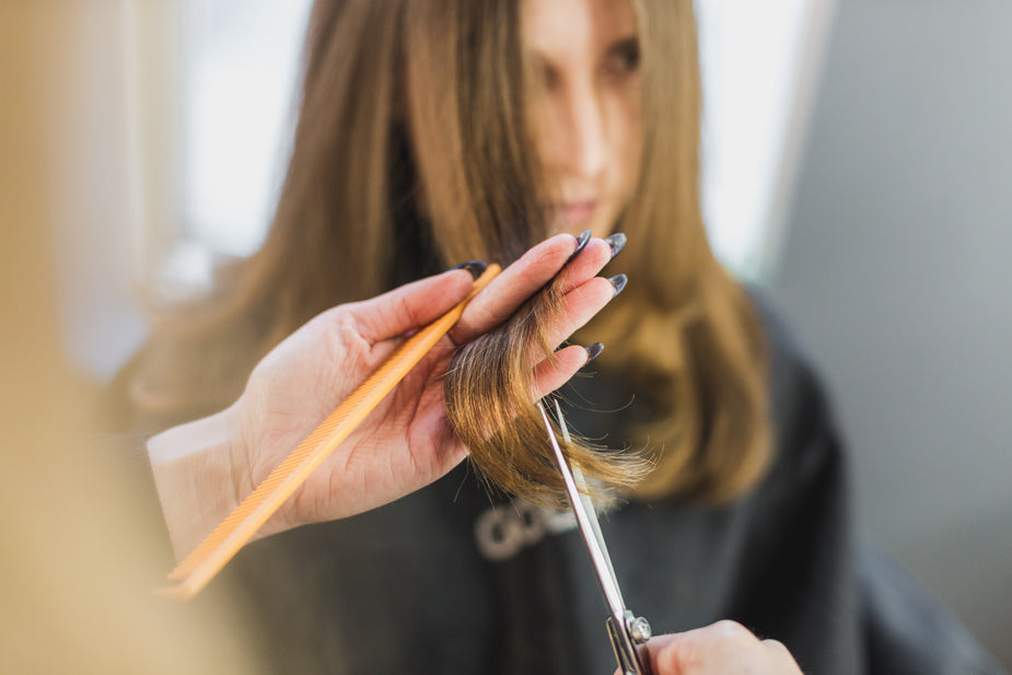 Woman getting hair cut