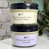 Two jars of Simply Soap Silk and Shea Hand Cream stacked vertically. The top jar is Oatmeal & Honey with a cream-colored label and black lid, and the bottom jar is Lavender with a light purple label and black lid.