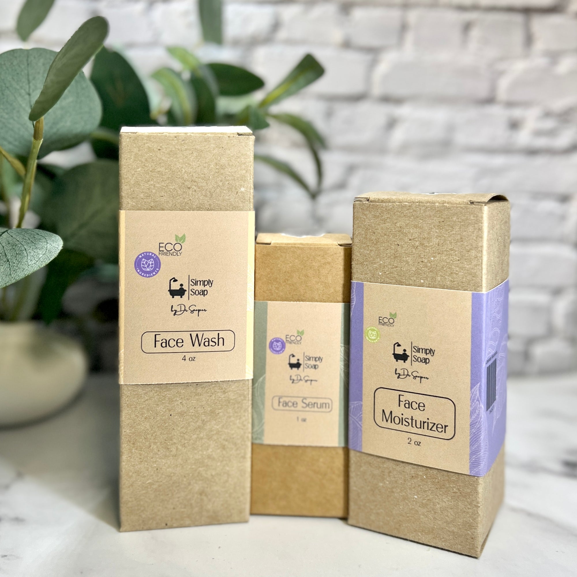 Three cardboard boxes labeled 'Face Wash', 'Face Serum', and 'Face Moisturizer' with 'Simply Soap' branding on a light surface.