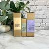 Three cardboard boxes with text on a marble surface with a plant and brick wall in the background