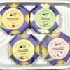 Another view of Four Solid Hair conditioner bars with different scents on a white tray.