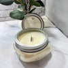 Apple vanilla harvest candle in a mason jar with a plant in the background