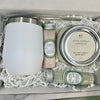 Set of candles and soaps in a gift box on a marble surface