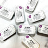 Dr. Soaper Natural Lip Balm tins scattered on white background