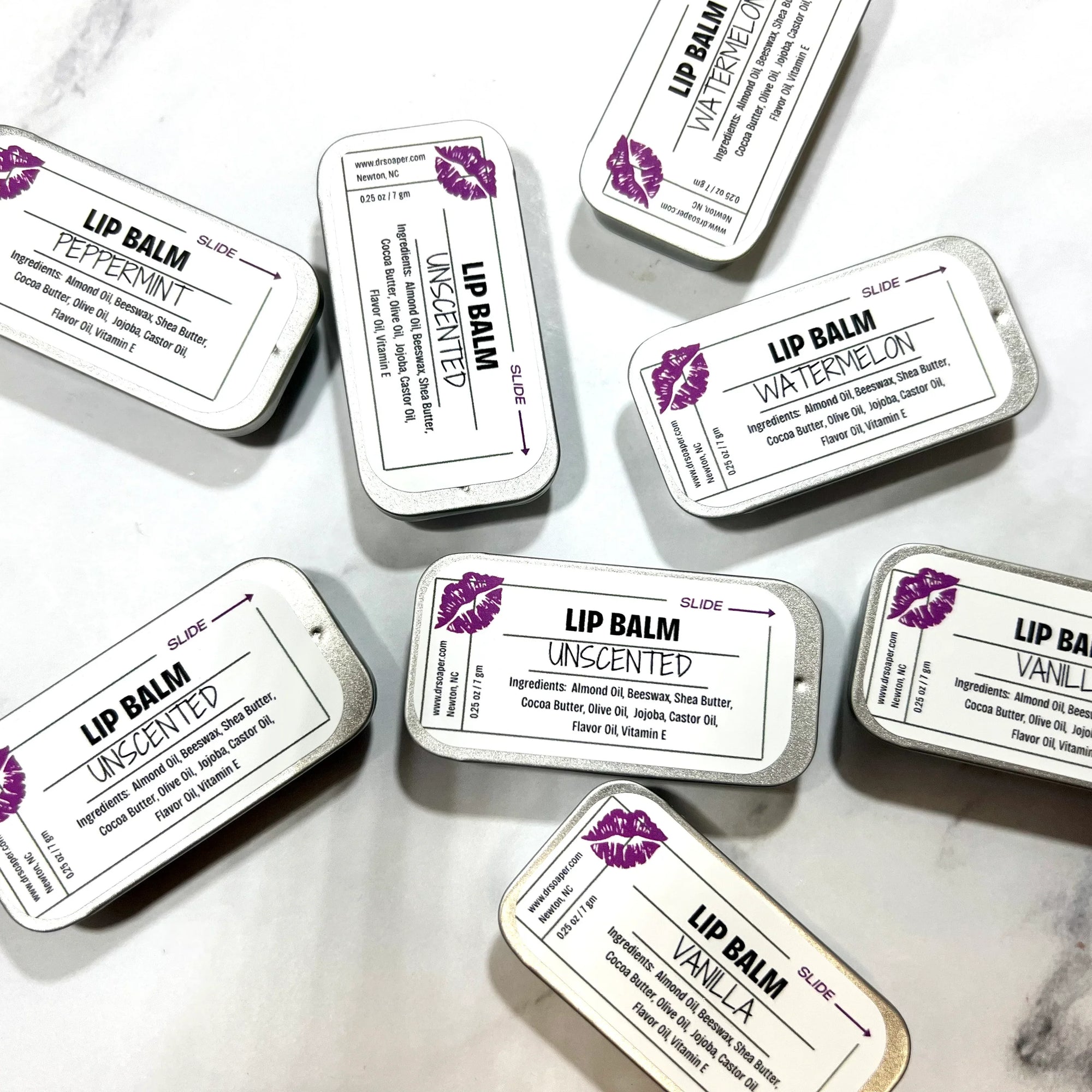 Dr. Soaper Natural Lip Balm tins scattered on white background
