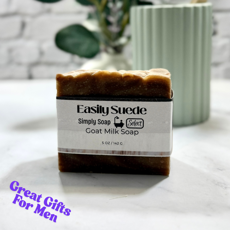 Bar of goat milk soap with a label on a marble surface, text 'Easily Suede' and 'Simply Soap' visible.