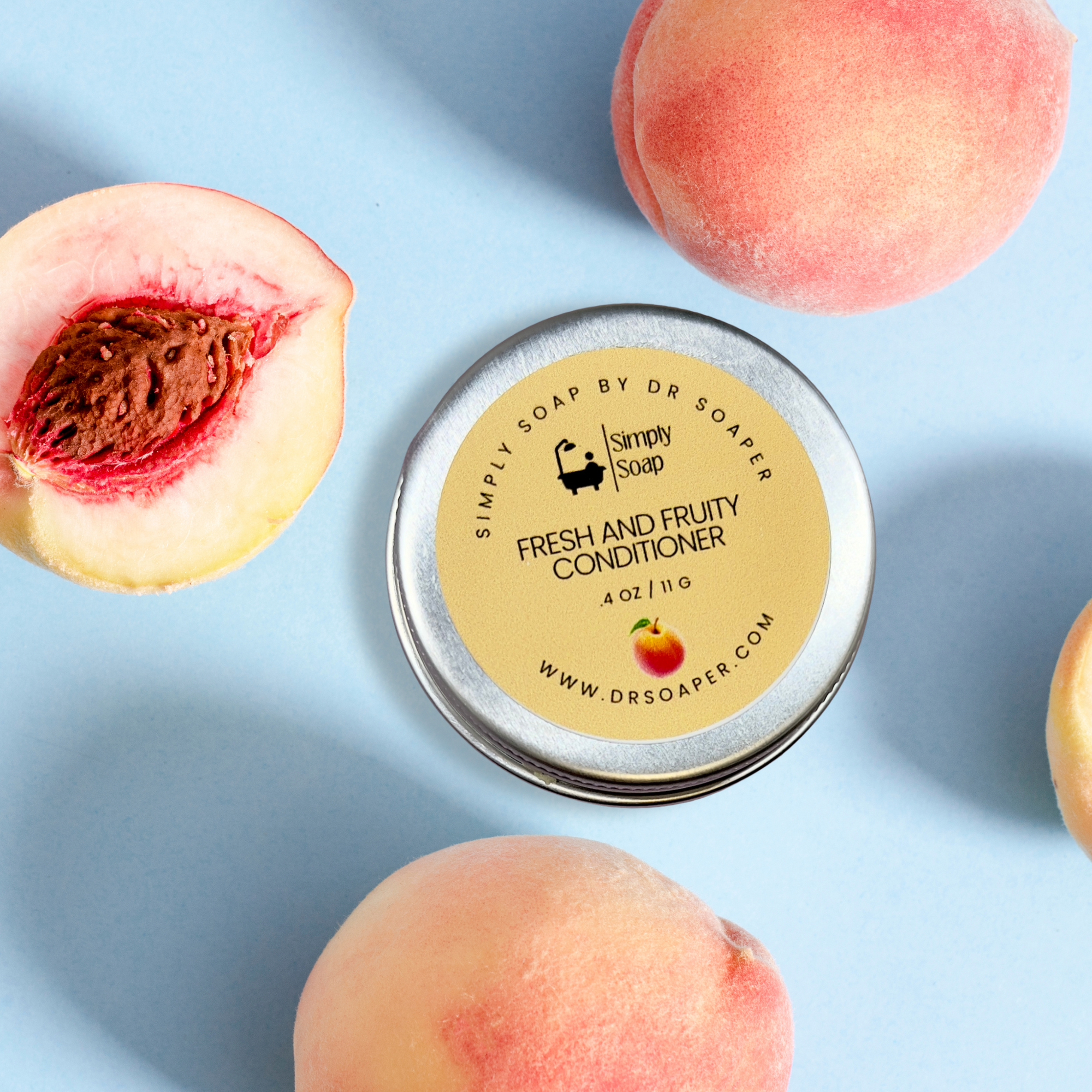 Tin of Simply Soap Fresh and Fruity Conditioner with peaches on a light blue background