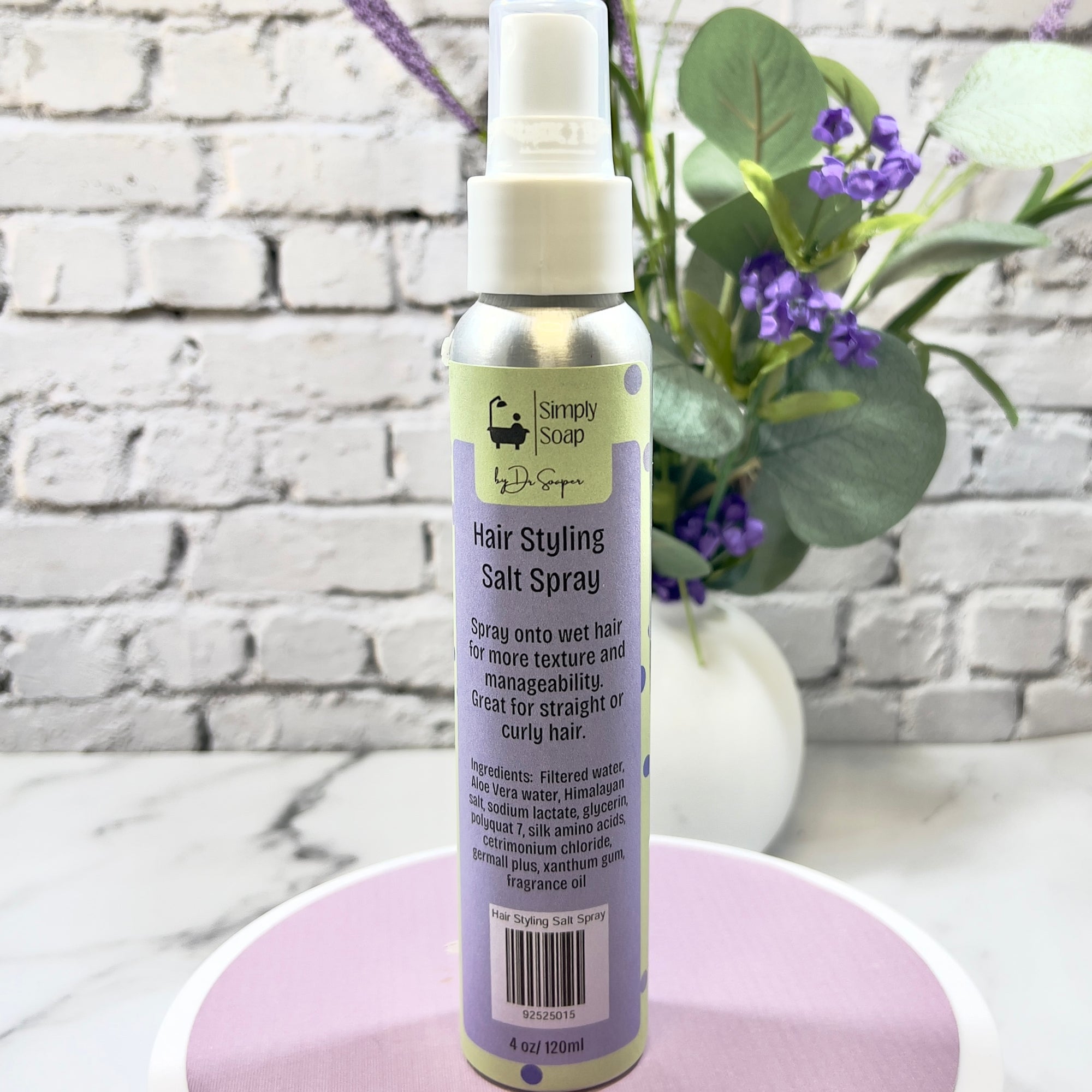 Hair styling salt spray bottle with a decorative background