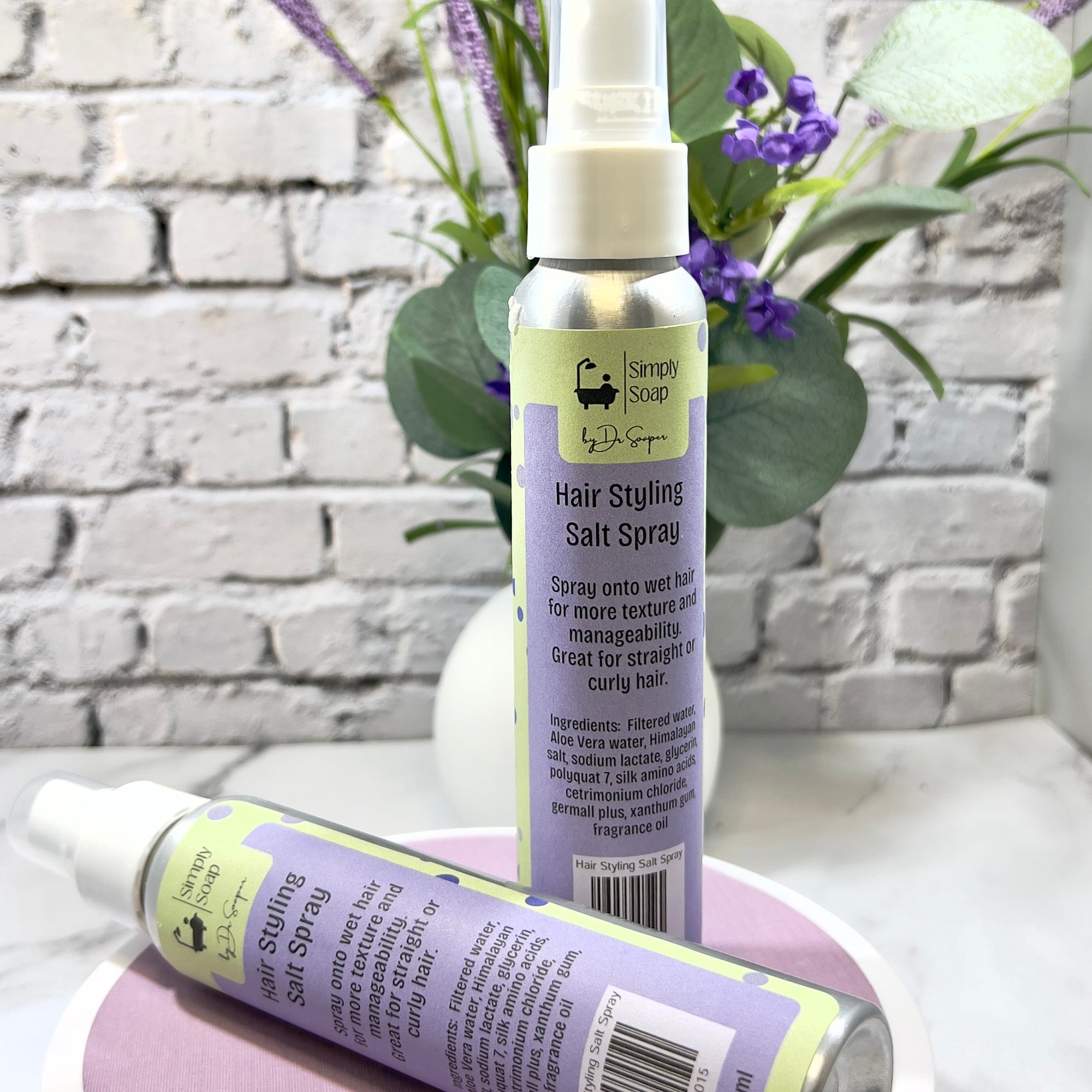 Hair styling salt spray bottle with a decorative background