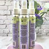 Three bottles of Simply Soap Hair Styling Salt Spray on a white surface with a gray brick wall background.