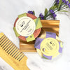 Two hair care bars with labels and a wooden comb on a white background