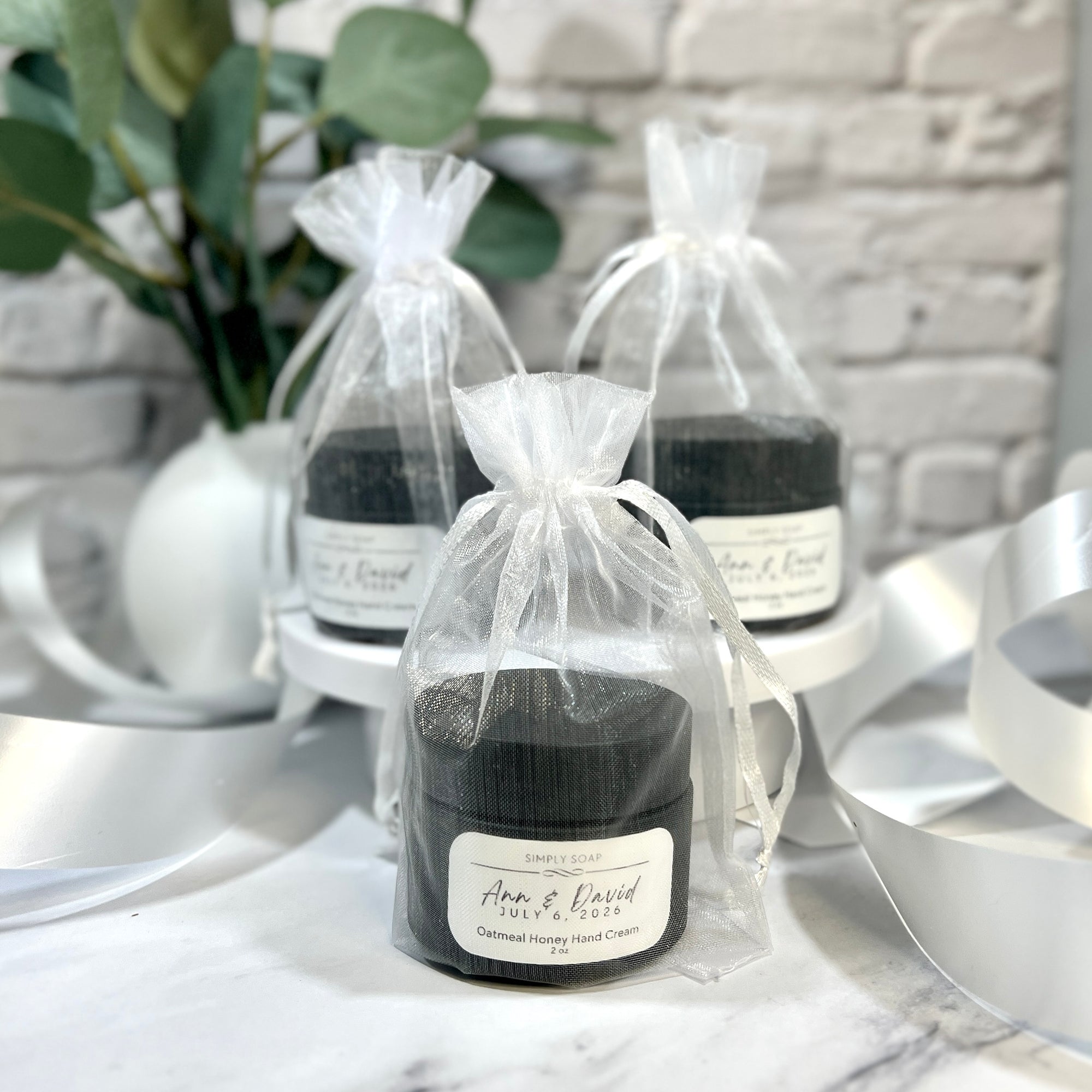 Black candles in clear drawstring bags on a marble surface with decorative elements.