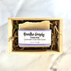 Bar of soap with a label in a wooden box on a light background