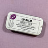 Honey Tea lip balm container with label on a purple background