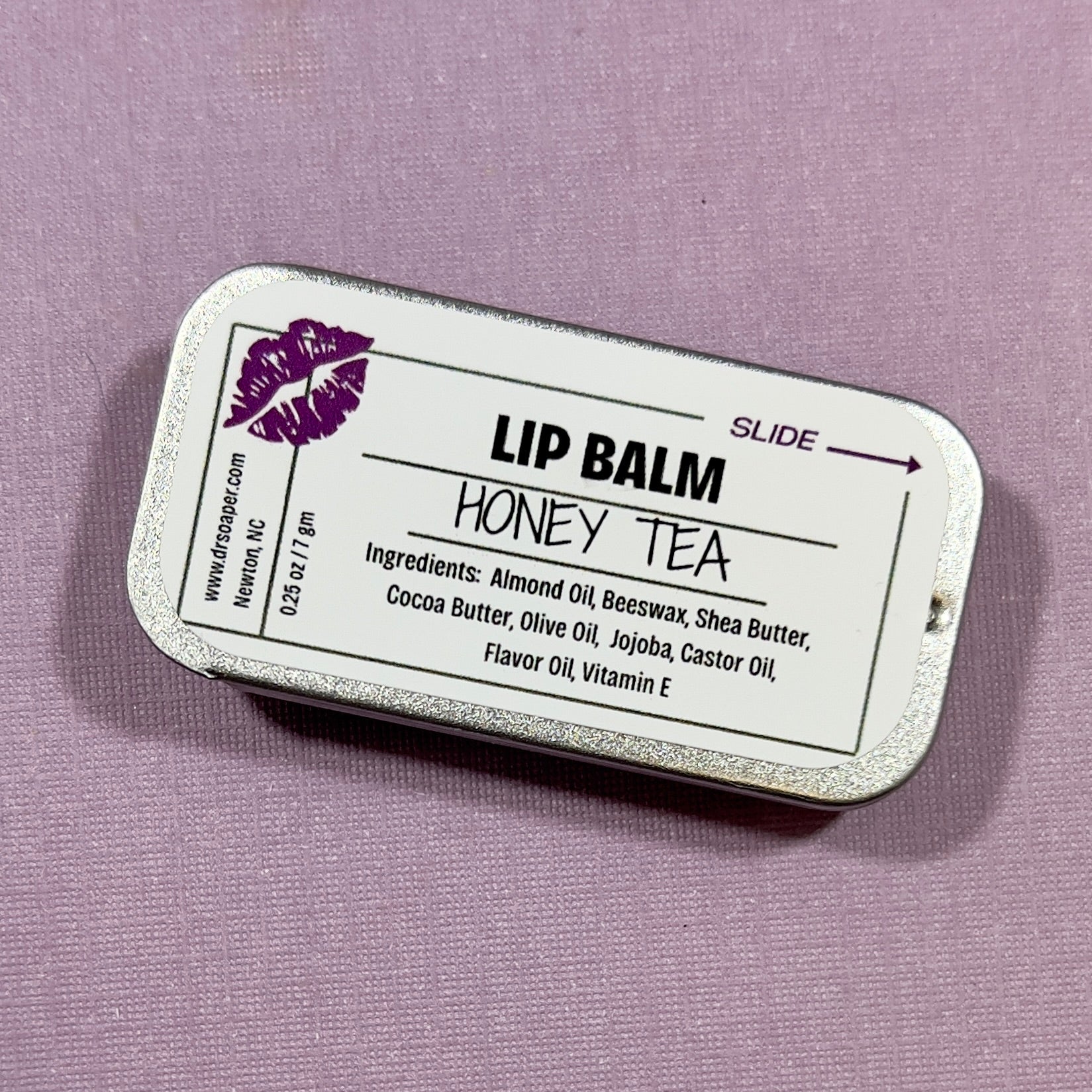 Honey Tea lip balm container with label on a purple background