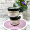 Two jars of Lavender Hand Cream on a white surface with a blurred background