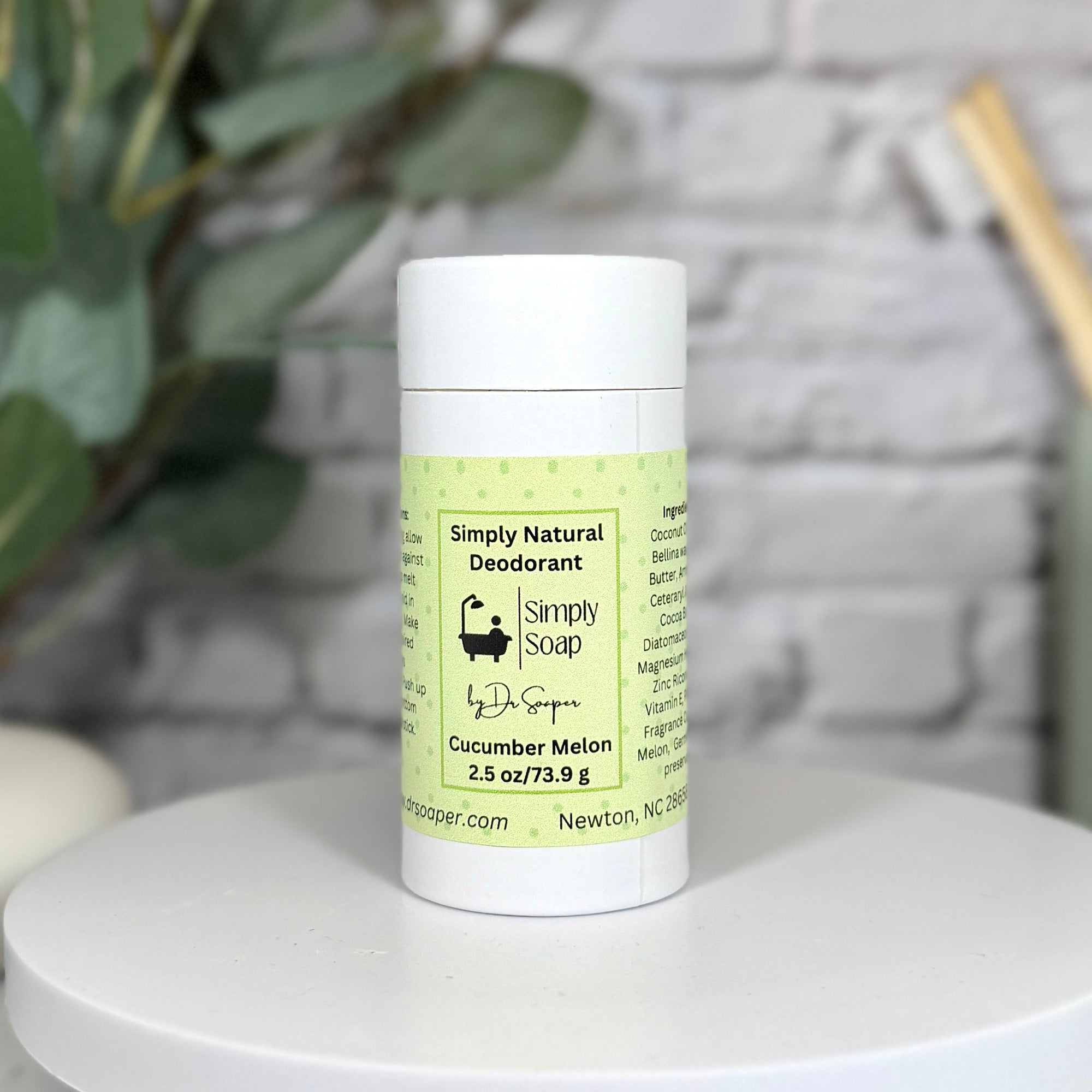 Simply Natural Deodorant by Simply Soap on a white surface with a blurred background
