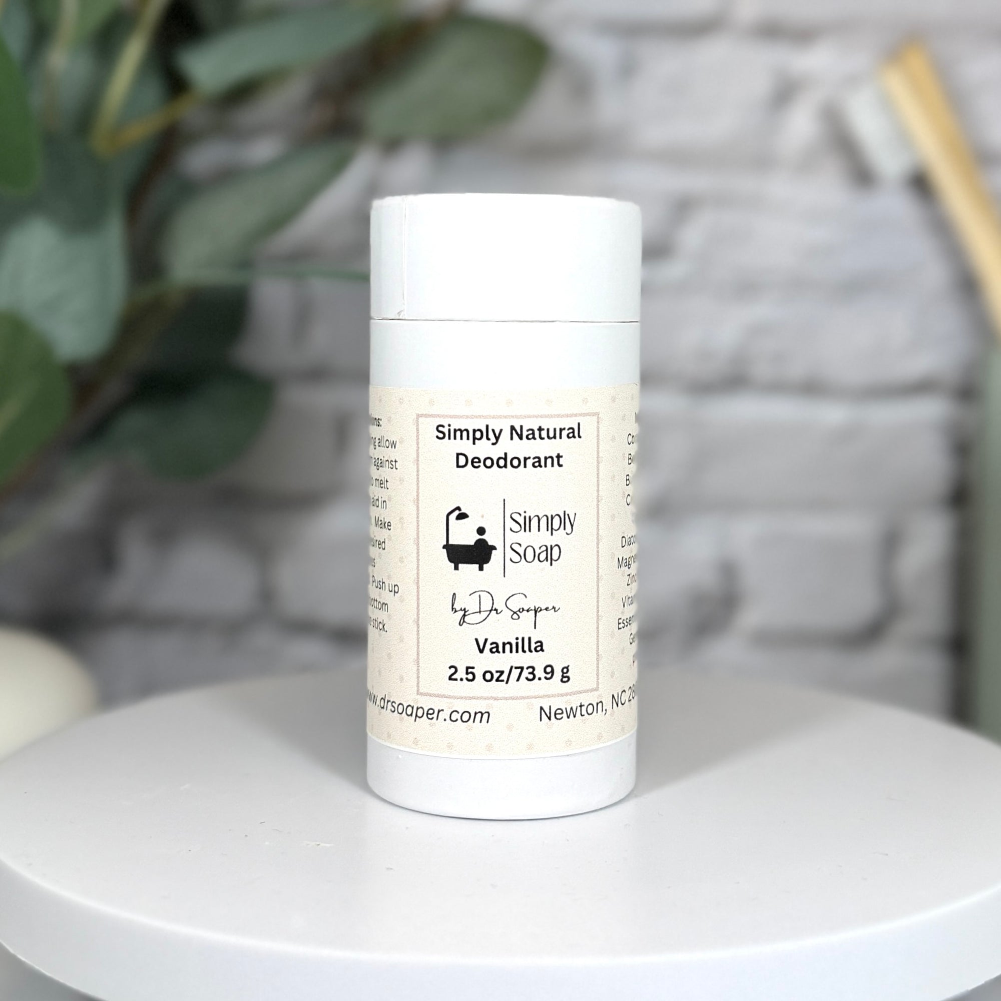 Simply Natural Deodorant stick on a white surface with a blurred background