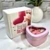 Heart-shaped pink candle in a tin with 'Ocean Rose Soy Candle' packaging on a marble surface.