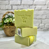 Stack of green soap bars with 'Simply Soap' branding on a marble surface.