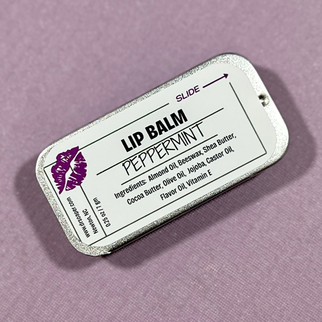 Lip balm packaging with a purple lips on a lavender background