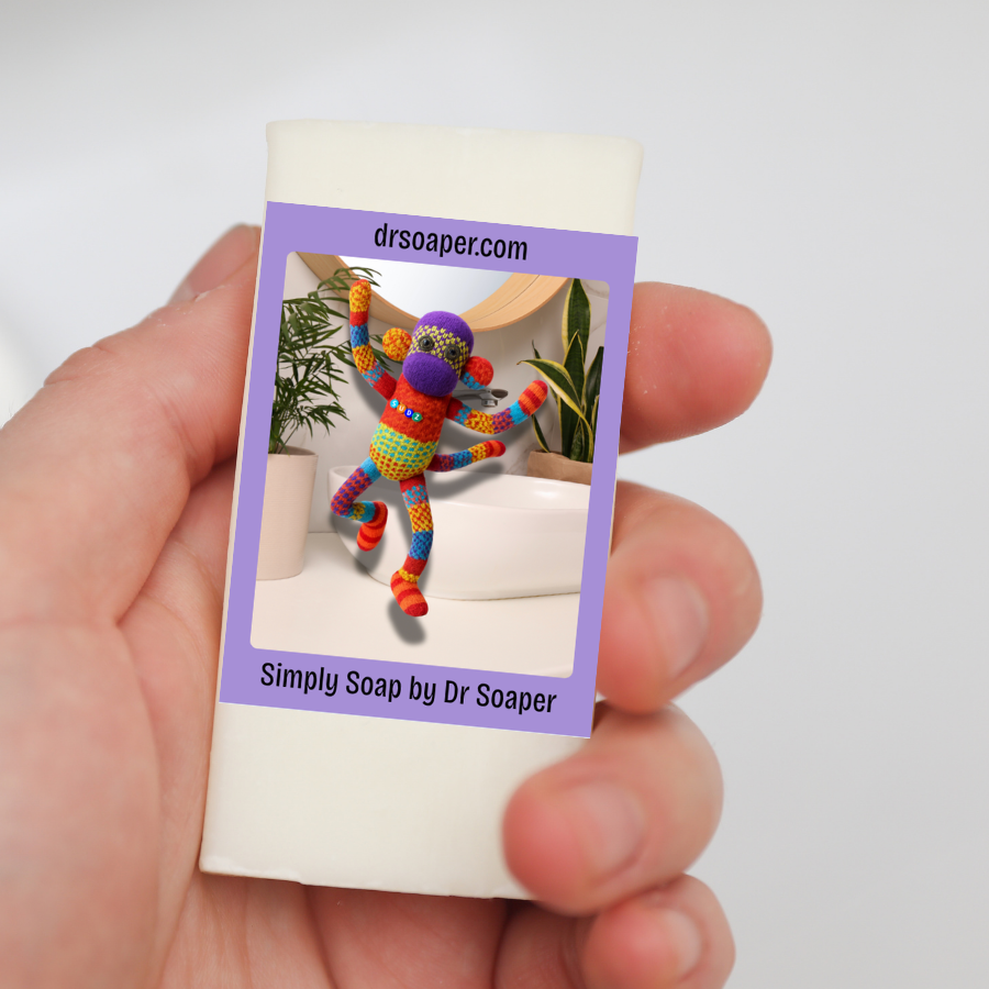 A hand holds a white rectangular soap bar wrapped purple wrapper with SUDZ jumping
