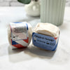 Two bars of shave soap with labels on a light surface