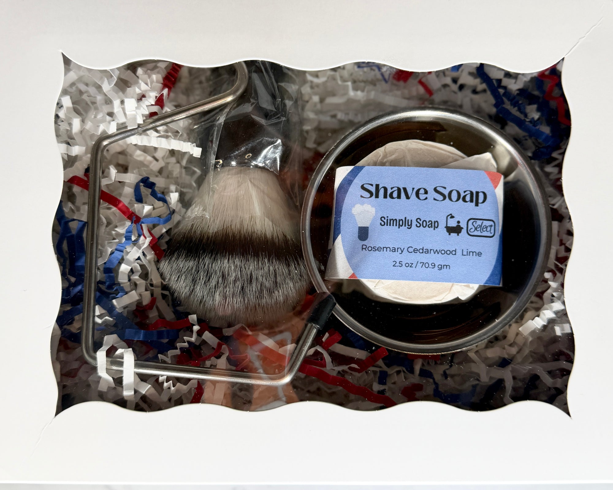 Shave brush and soap set with decorative packaging on a white background
