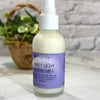 Bottle of 'Simply Light Lotion Mist' with a purple label on a light surface.