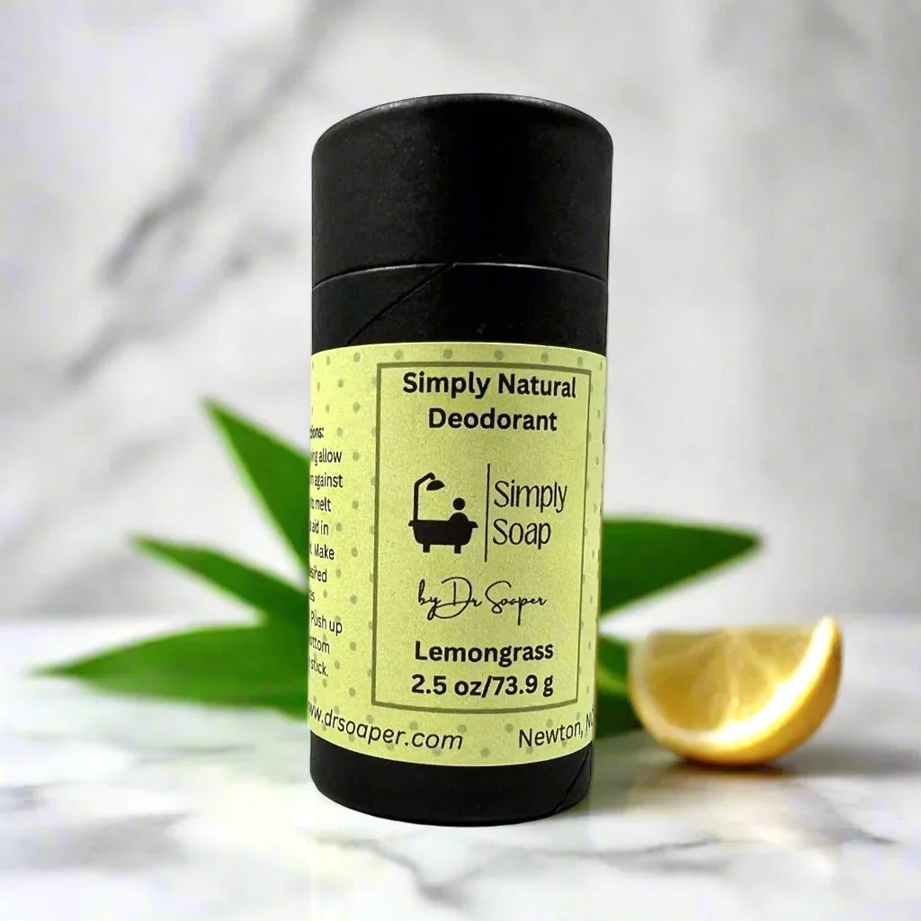 Lemon grass, natural deodorant on marble surface with lemon and greenery in the background ￼