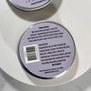 Close-up of the bottom of a round metal tin showing product instructions, ingredients, a barcode, and the website www.drsaper.
