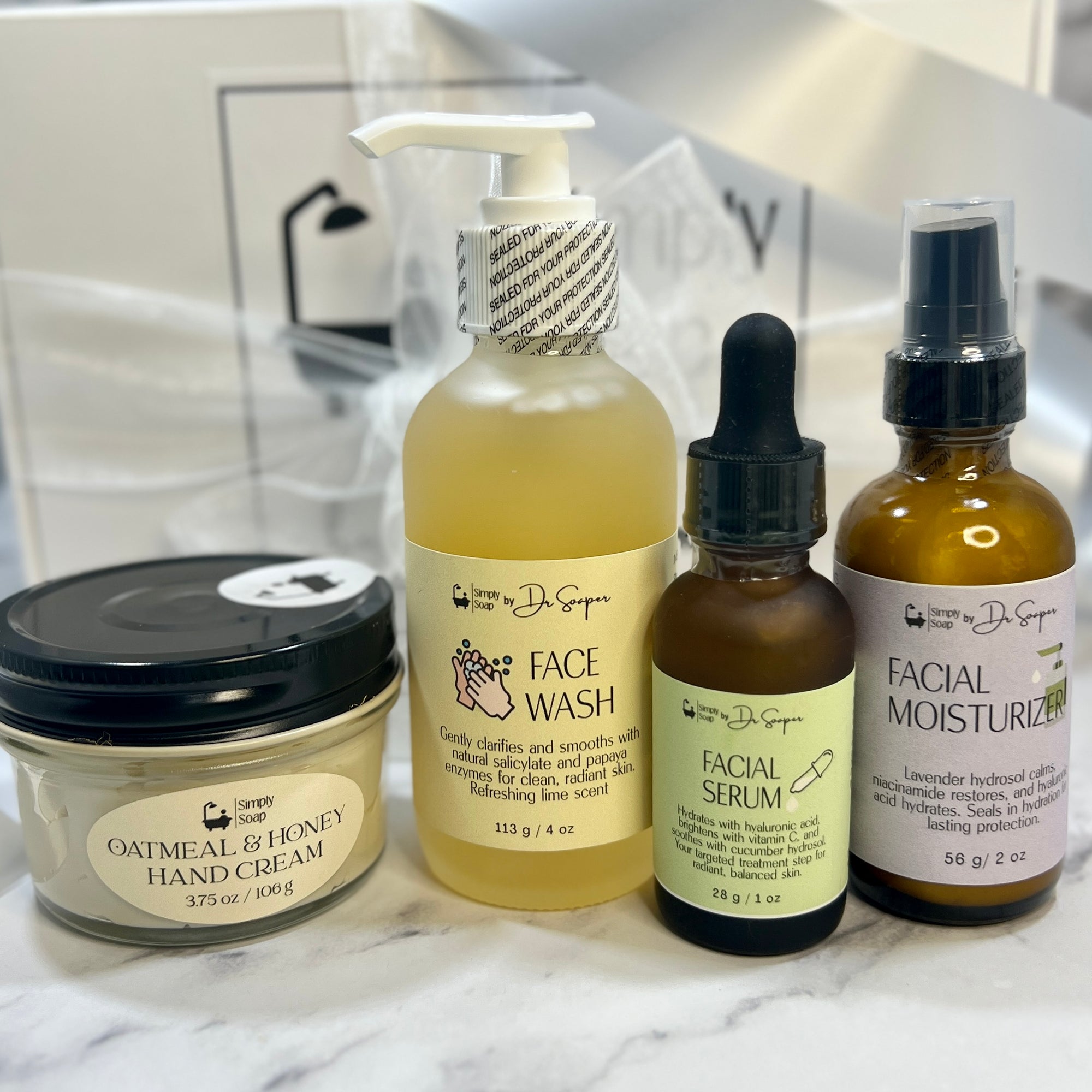 Collection of skincare products including face wash, serum, moisturizer, and hand cream on a marble surface.