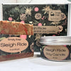 The image shows a Sleigh Ride Soap and Soy Candle set with packaging that has a Christmas-themed design, including a bar of soap and a candle with the product labels visible.