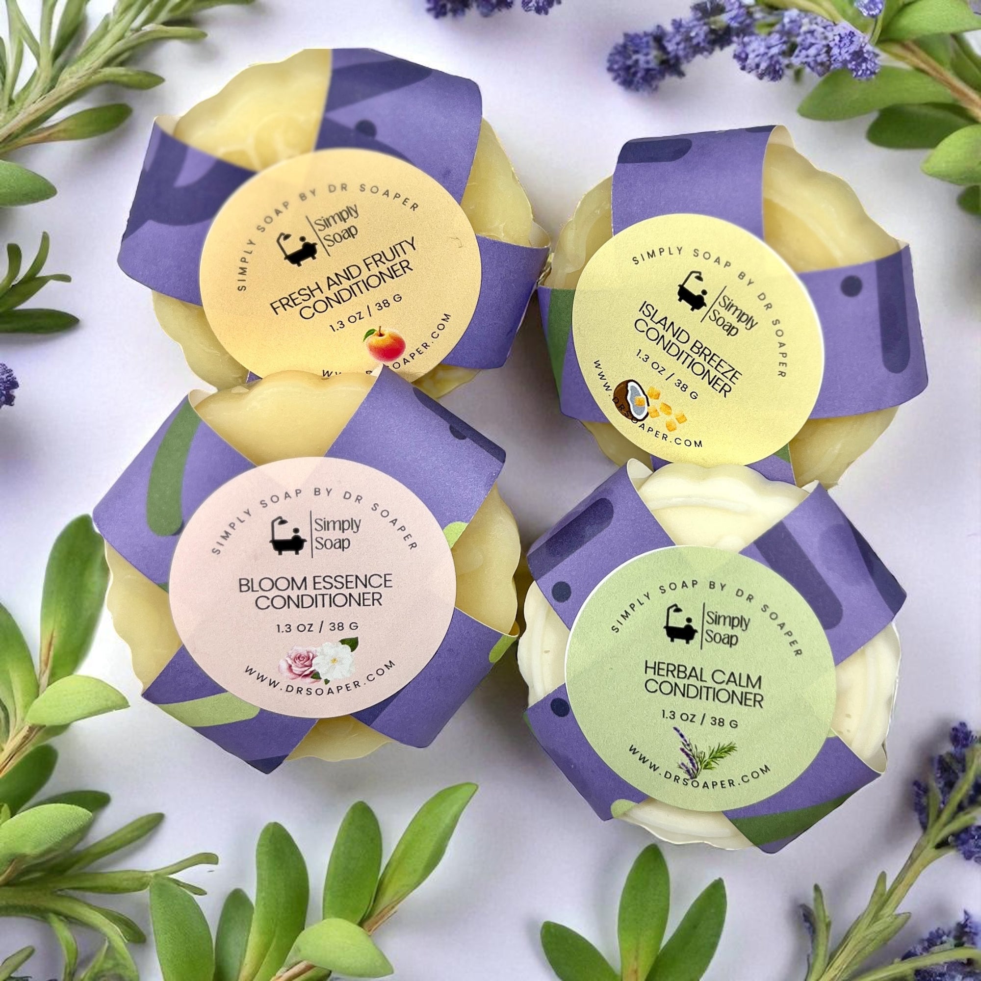 Four Simply Soap solid conditioner bars with labels on a white background with greenery.
