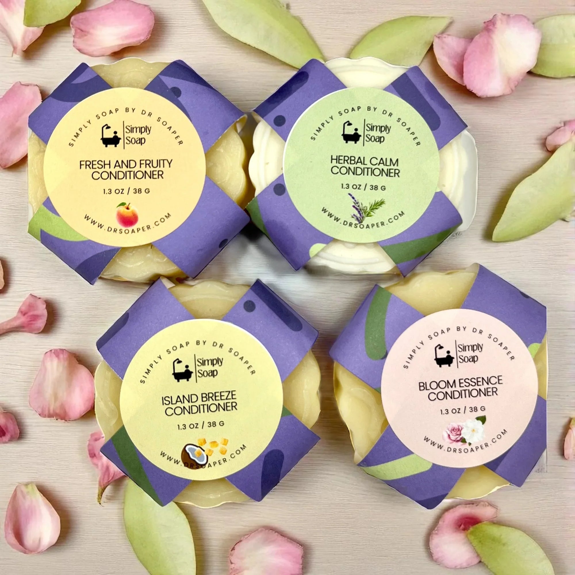 Four Solid conditioner bars with colorful labels on a light background with flowers.