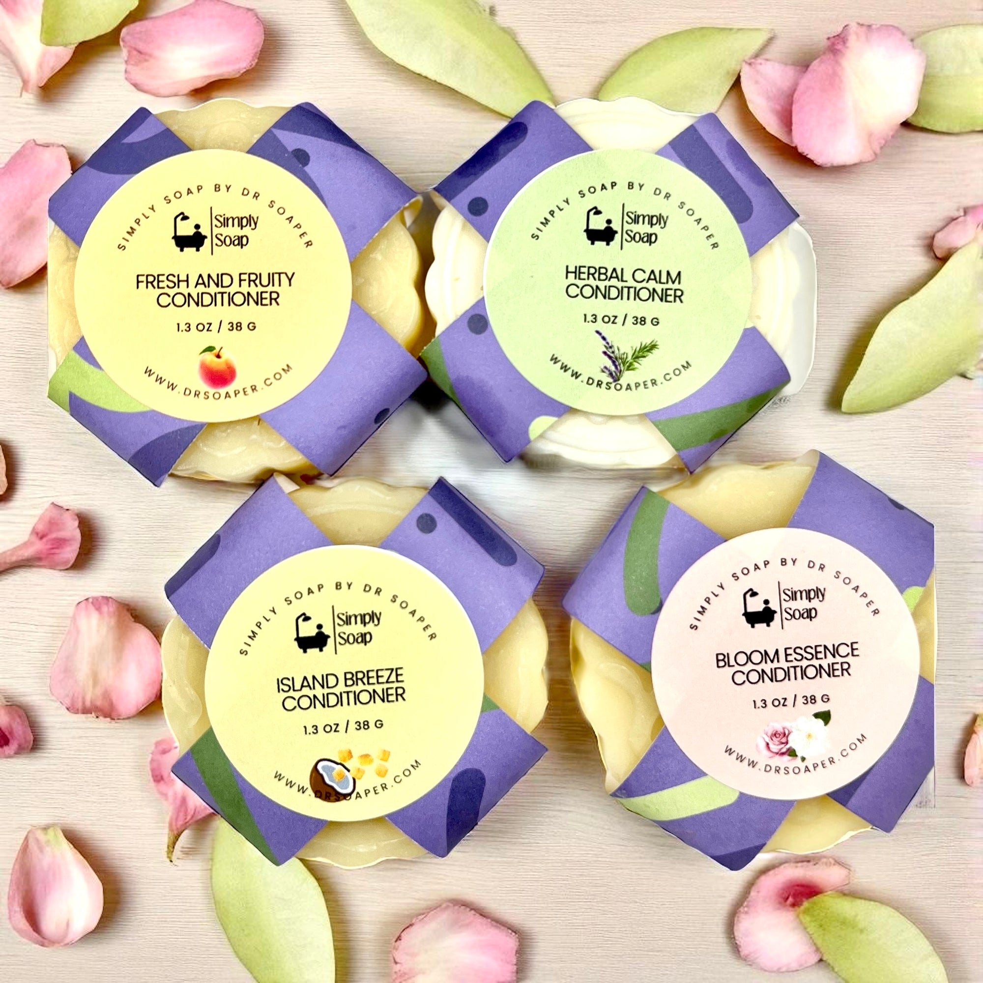 Four packages of Simply Soap conditioner bars on a light wooden surface with flower petals.