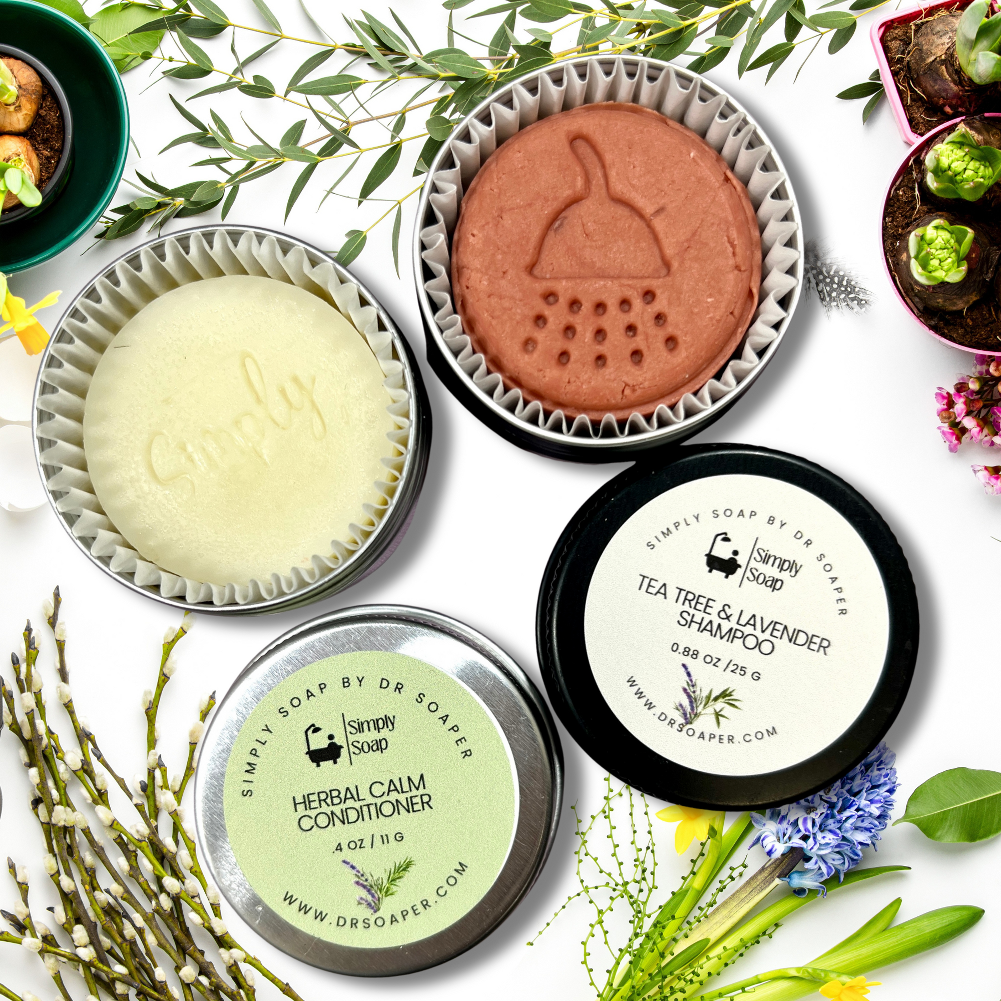 Collection of Simply Soap products including solid conditioner and shampoo bar on a white background with greenery.