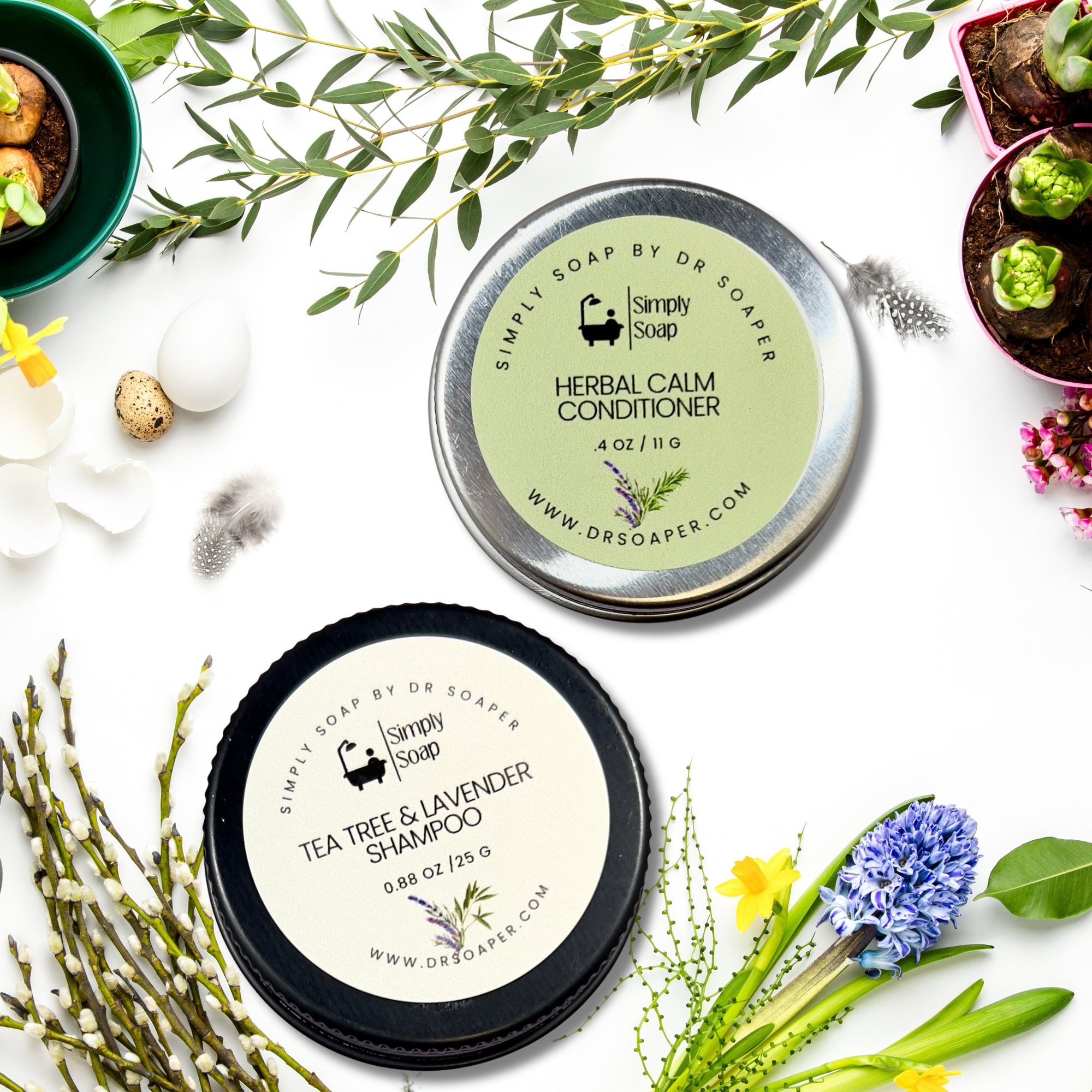 Solid shampoo and conditioner containers with herbs and flowers on a white background