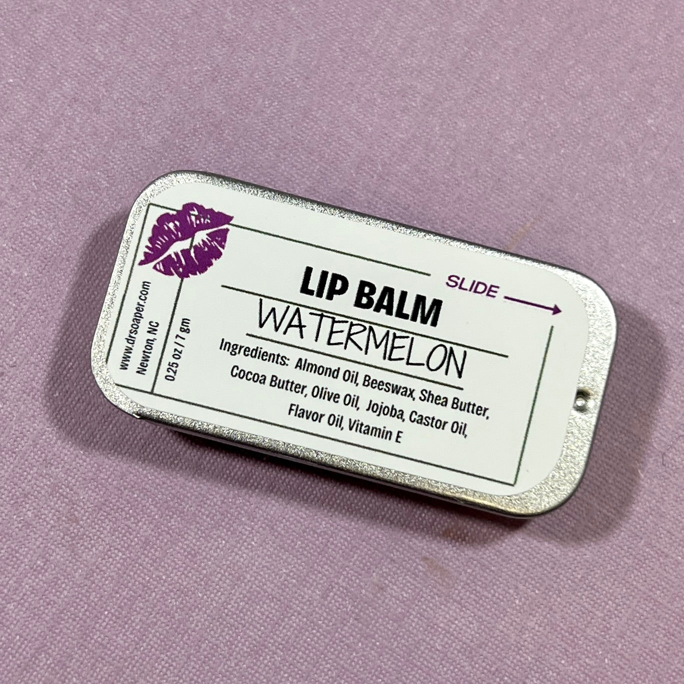 Lip balm container with 'Watermelon' flavor on a purple background