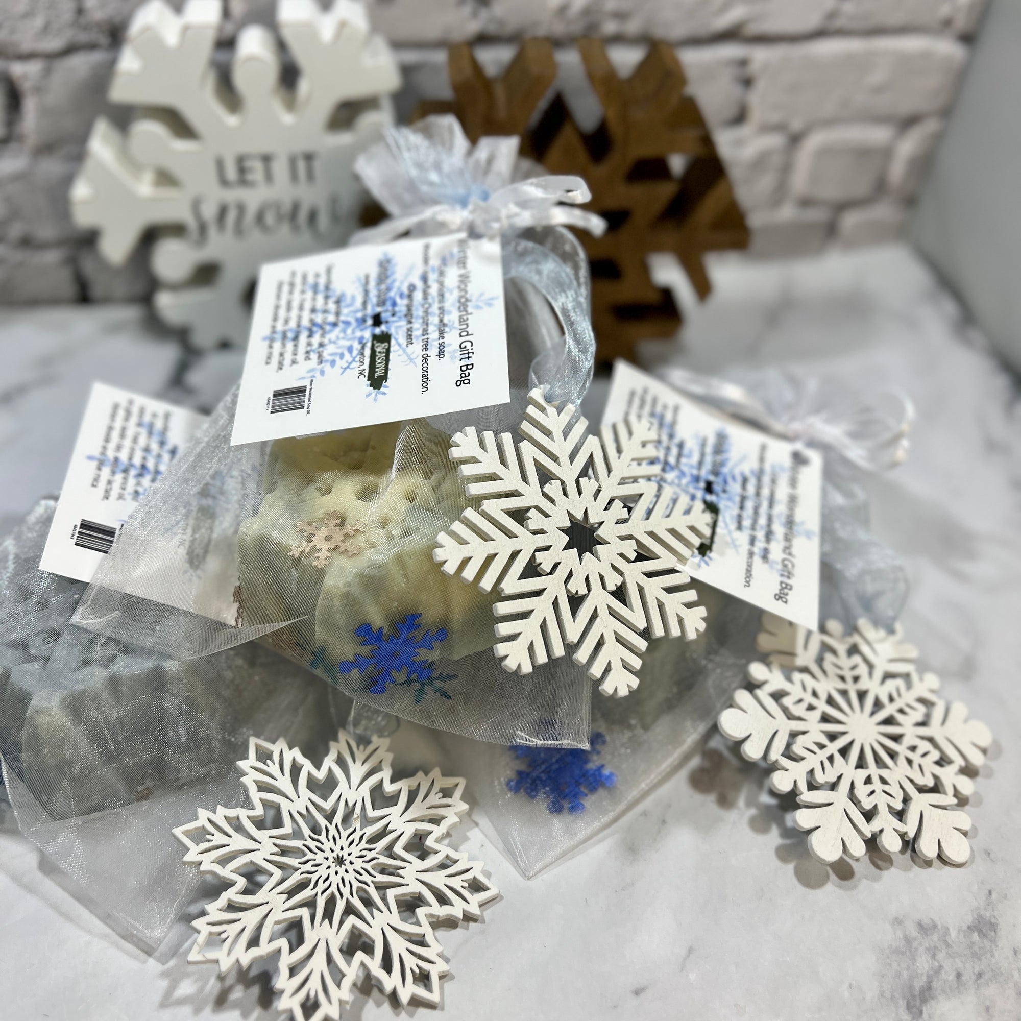 Packaged tea bags with snowflake designs on a decorative surface